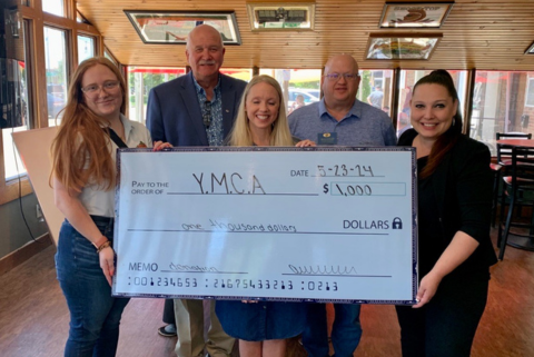 Tim Barry and Brian Songer presenting a $1,000 check to the YMCA representatives